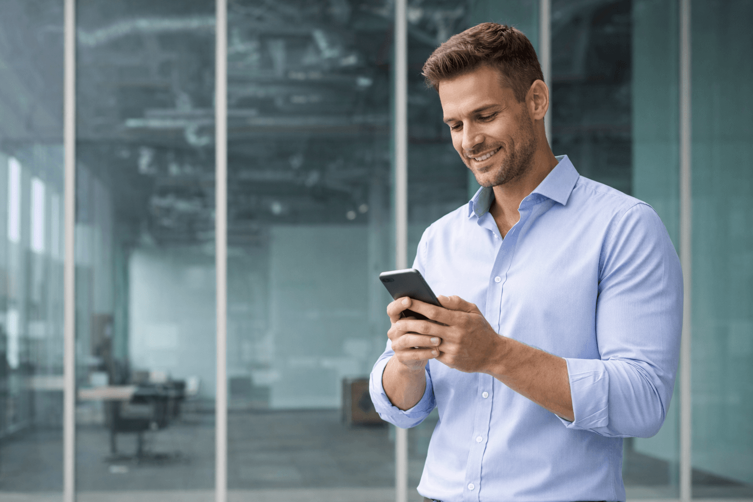 Happy businessman texting