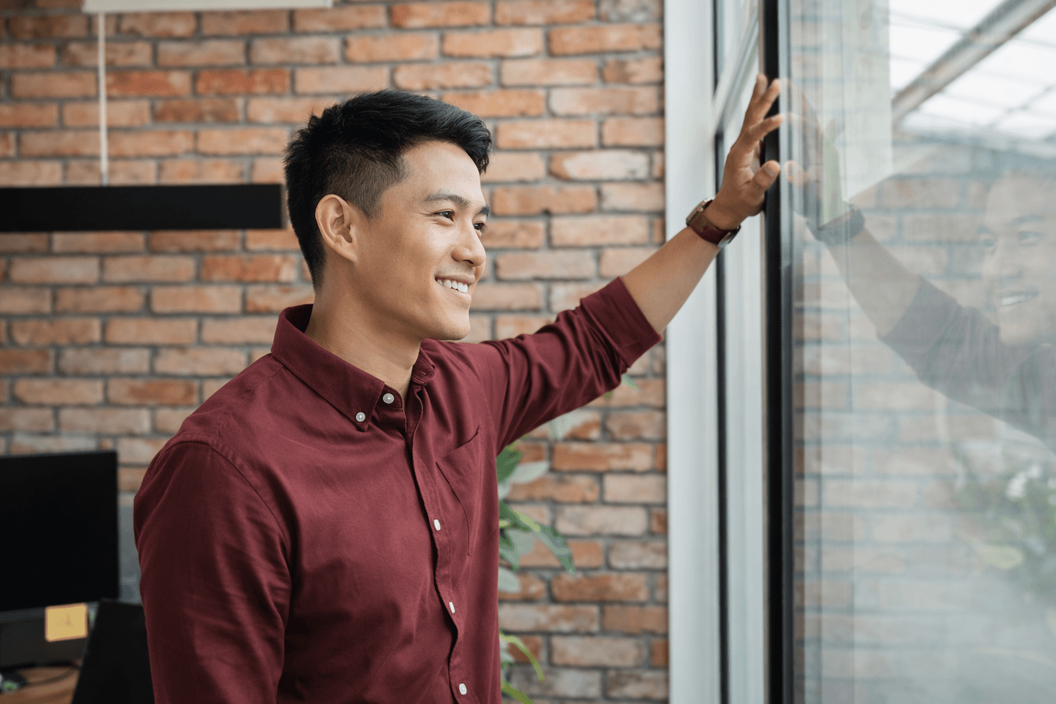 Happy man looking out window