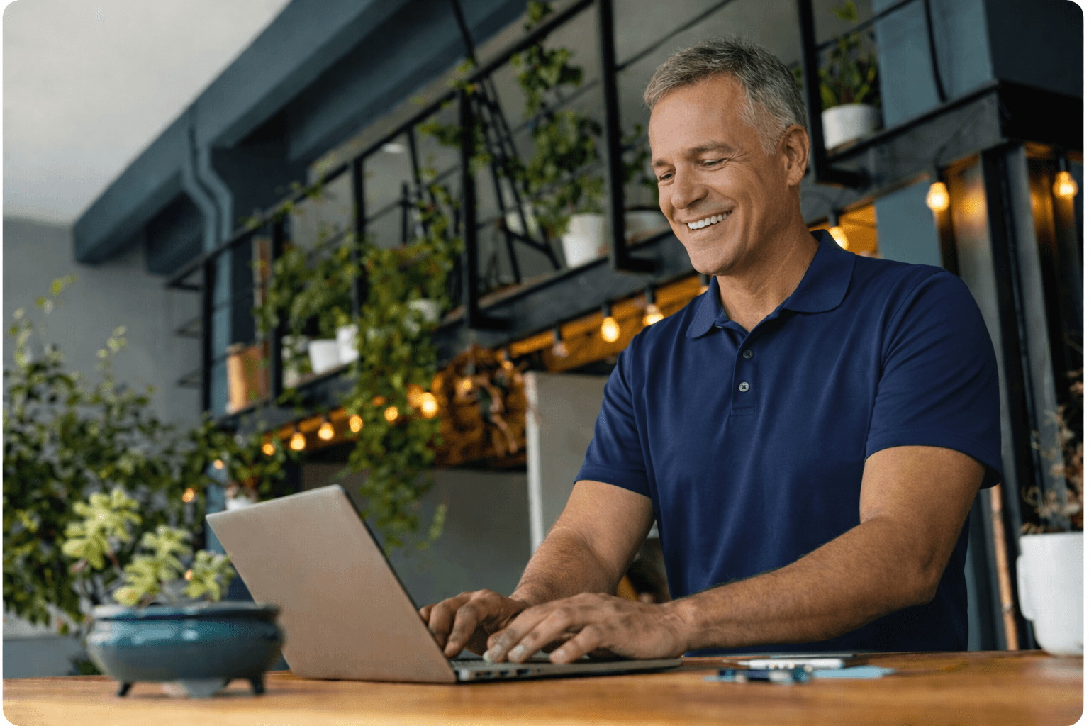 Man on laptop with products